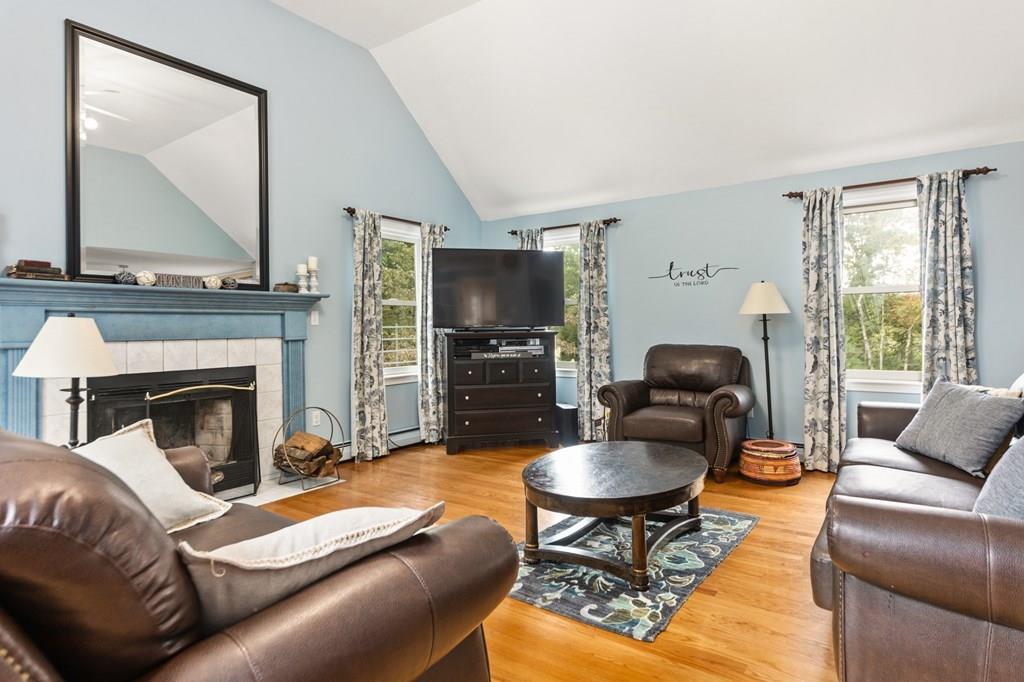 37 Middle Road Newbury, MA 01951 - Photo 2 of 42 a living room with furniture a flat screen tv and a fireplace