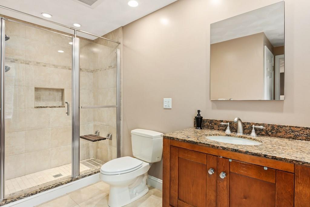 37 Middle Road Newbury, MA 01951 - Photo 21 of 42 a bathroom with a granite countertop toilet sink shower and mirror