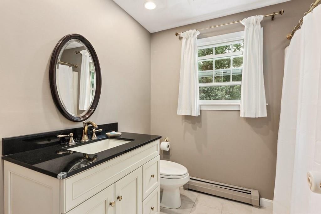 37 Middle Road Newbury, MA 01951 - Photo 29 of 42 a bathroom with a sink a toilet and a mirror