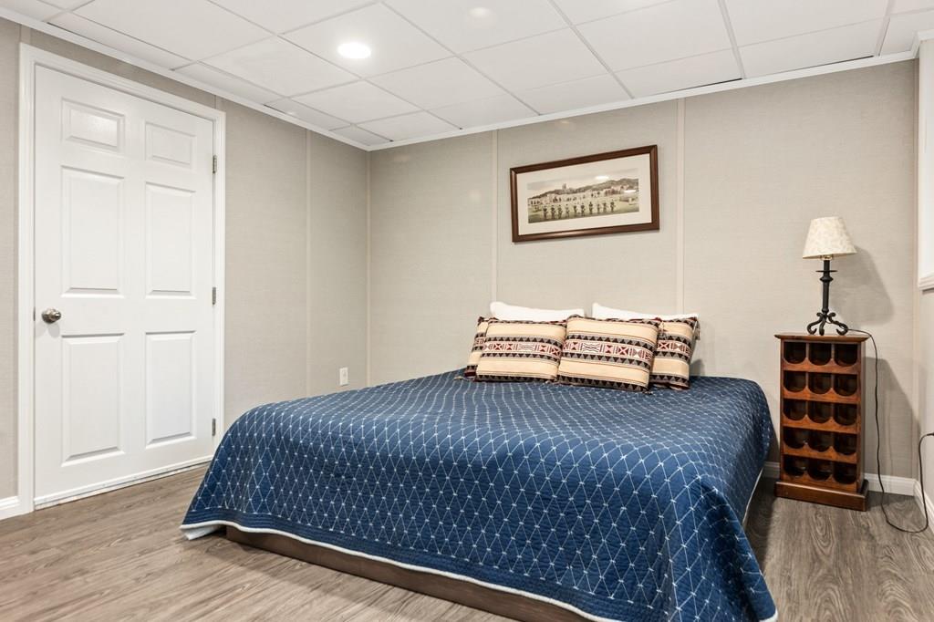 37 Middle Road Newbury, MA 01951 - Photo 30 of 42 a bedroom with a bed and a chandelier