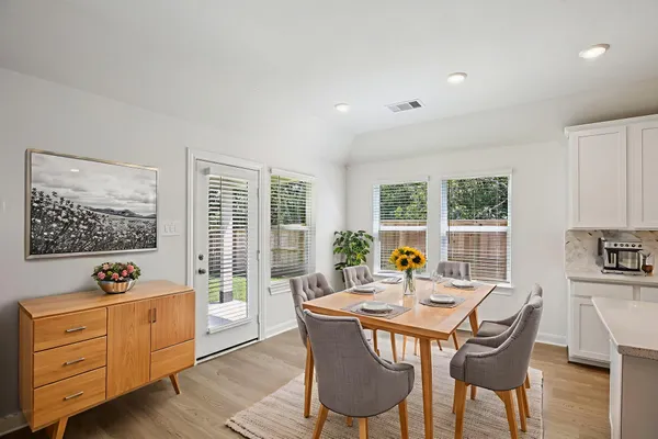 a dining room with furniture and window