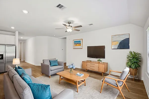 a living room with furniture and a flat screen tv