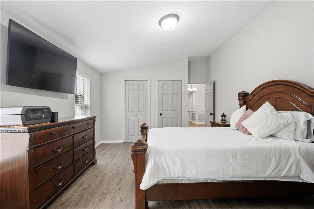 1295 Double Bridges Road Winder, GA 30680 - Photo 22 of 57 a bedroom with a bed and a flat screen tv