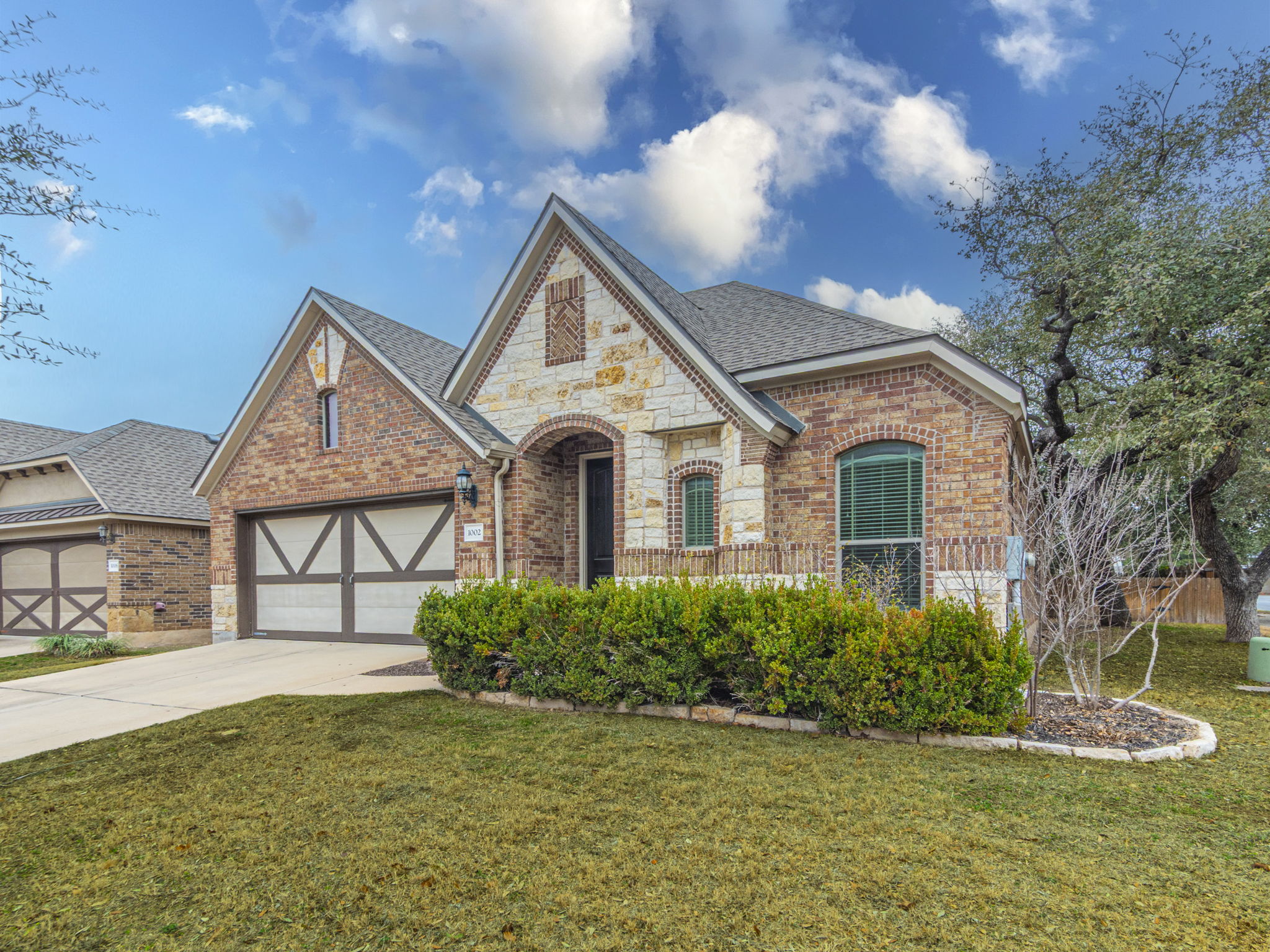 1002 Boxwood Loop Georgetown, TX 78628 - Photo 1 of 25 View of front of property with brick siding, concrete driveway, a front yard, and roof with shingles