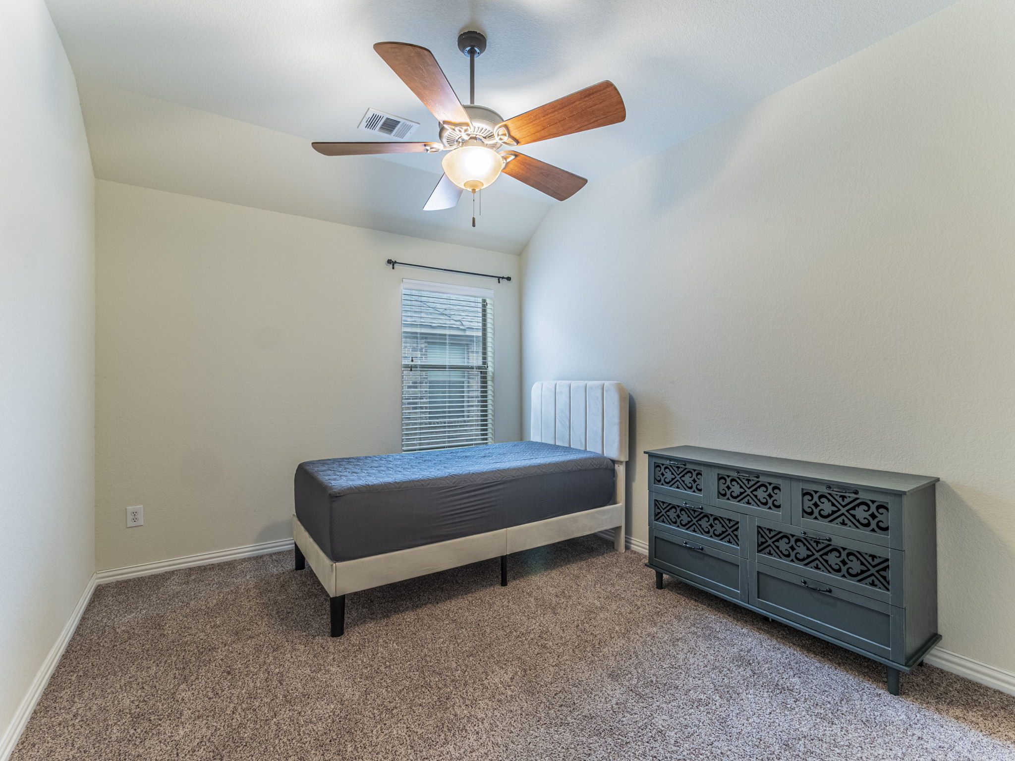 1002 Boxwood Loop Georgetown, TX 78628 - Photo 15 of 25 Bedroom featuring vaulted ceiling, carpet, and ceiling fan