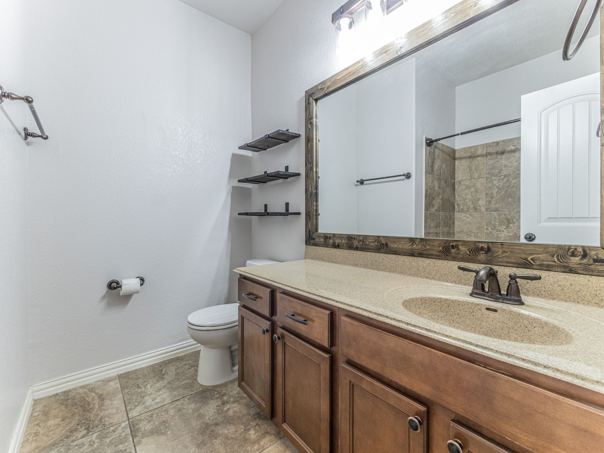 1002 Boxwood Loop Georgetown, TX 78628 - Photo 16 of 25 Full bath with vanity, a shower, and light tile patterned floors