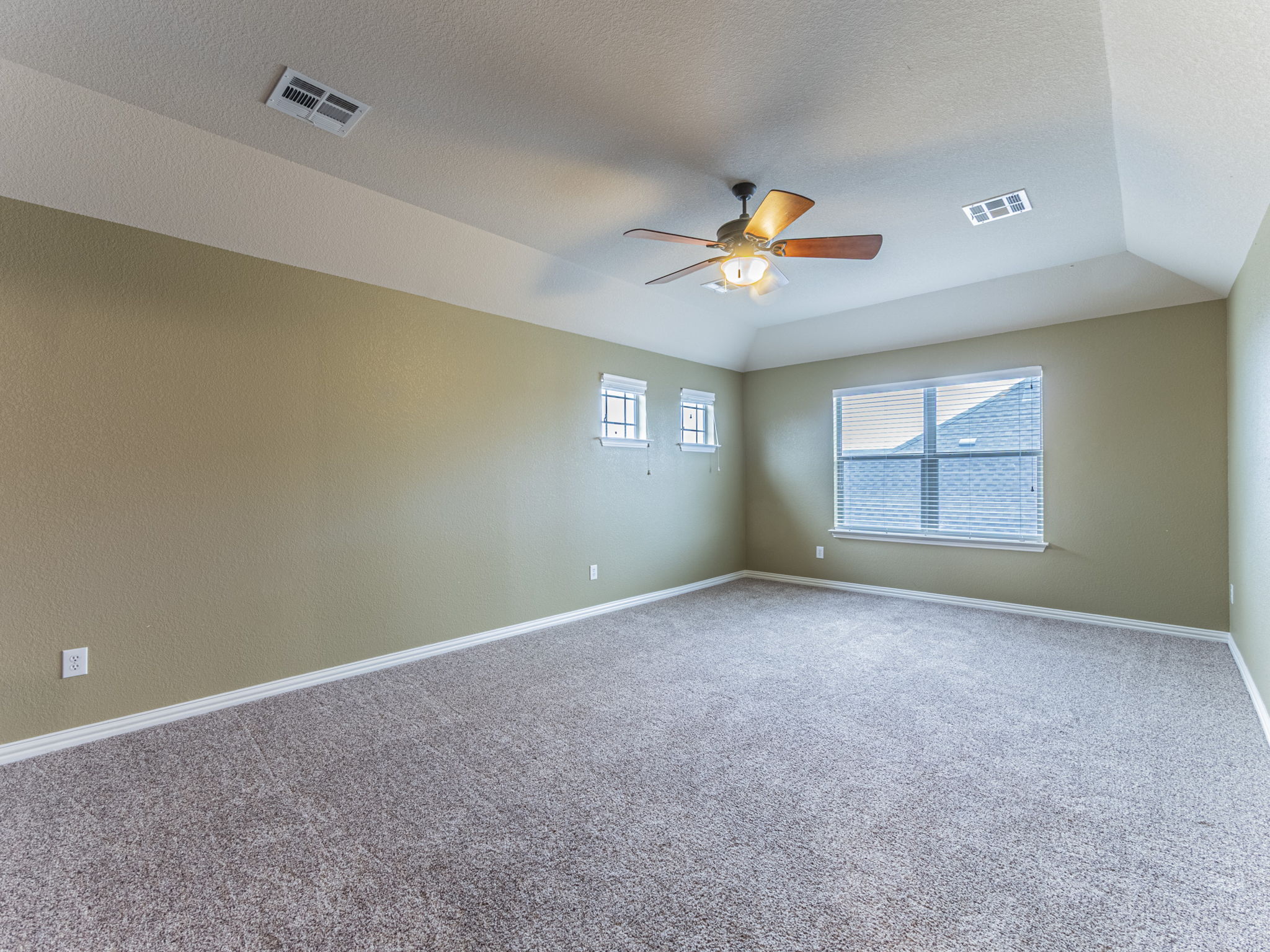 1002 Boxwood Loop Georgetown, TX 78628 - Photo 19 of 25 Carpeted spare room featuring ceiling fan, a textured ceiling, and a raised ceiling