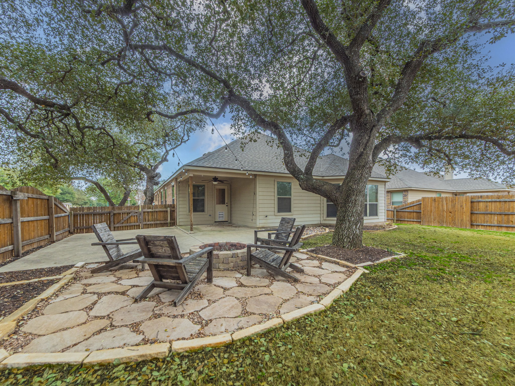 1002 Boxwood Loop Georgetown, TX 78628 - Photo 23 of 25 Back of property featuring an outdoor fire pit, a patio, ceiling fan, and a fenced backyard