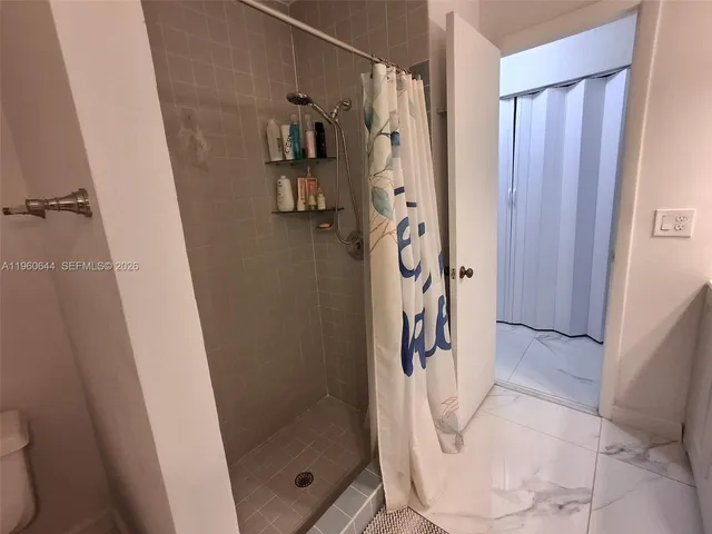 a bathroom with a shower and a sink