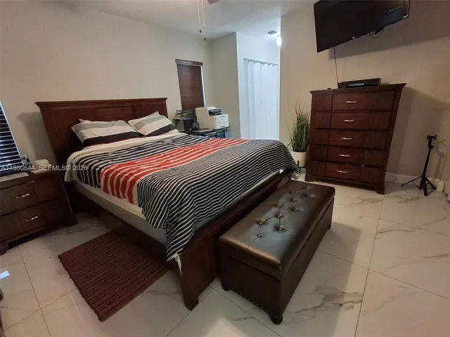 a bedroom with a bed and a mirror