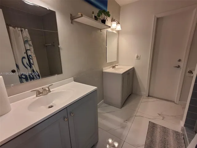 a bathroom with a sink vanity and mirror