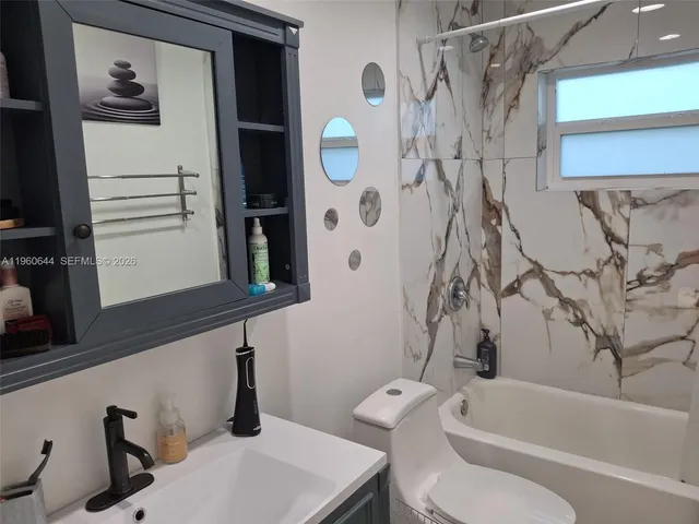 a bathroom with a toilet and a bathtub