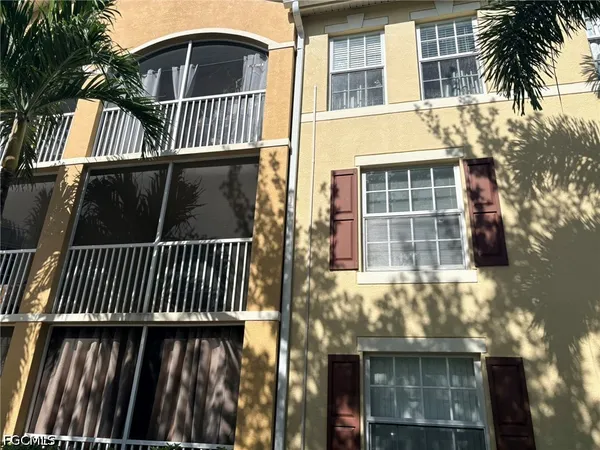 a view of a brick house with many windows