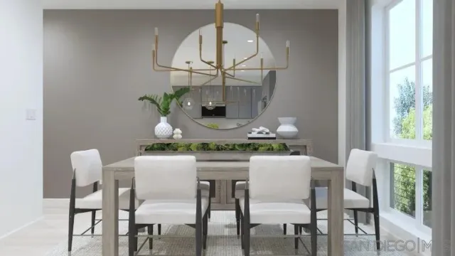 a dining room with furniture a potted plant and a chandelier