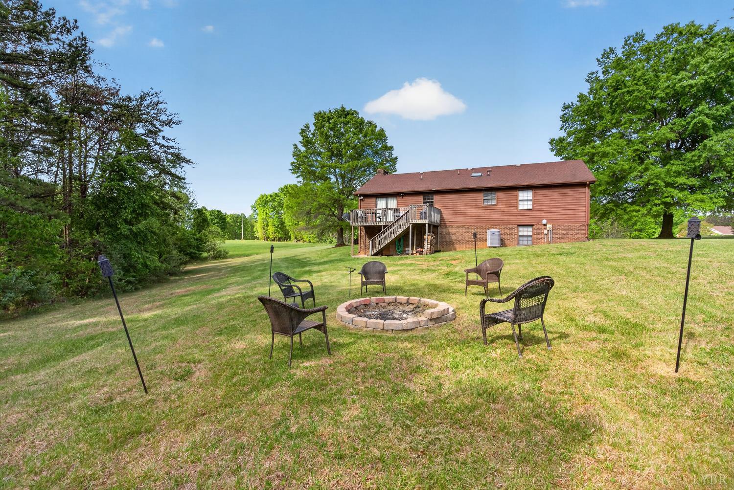 1002 Homeplace Road Rustburg, VA 24588 - Photo 42 of 48 a view of an chairs and table in the backyard