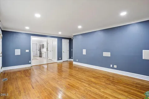 a view of an empty room with wooden floor