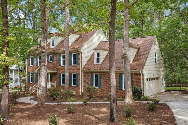 a view of multiple house with a tree in front