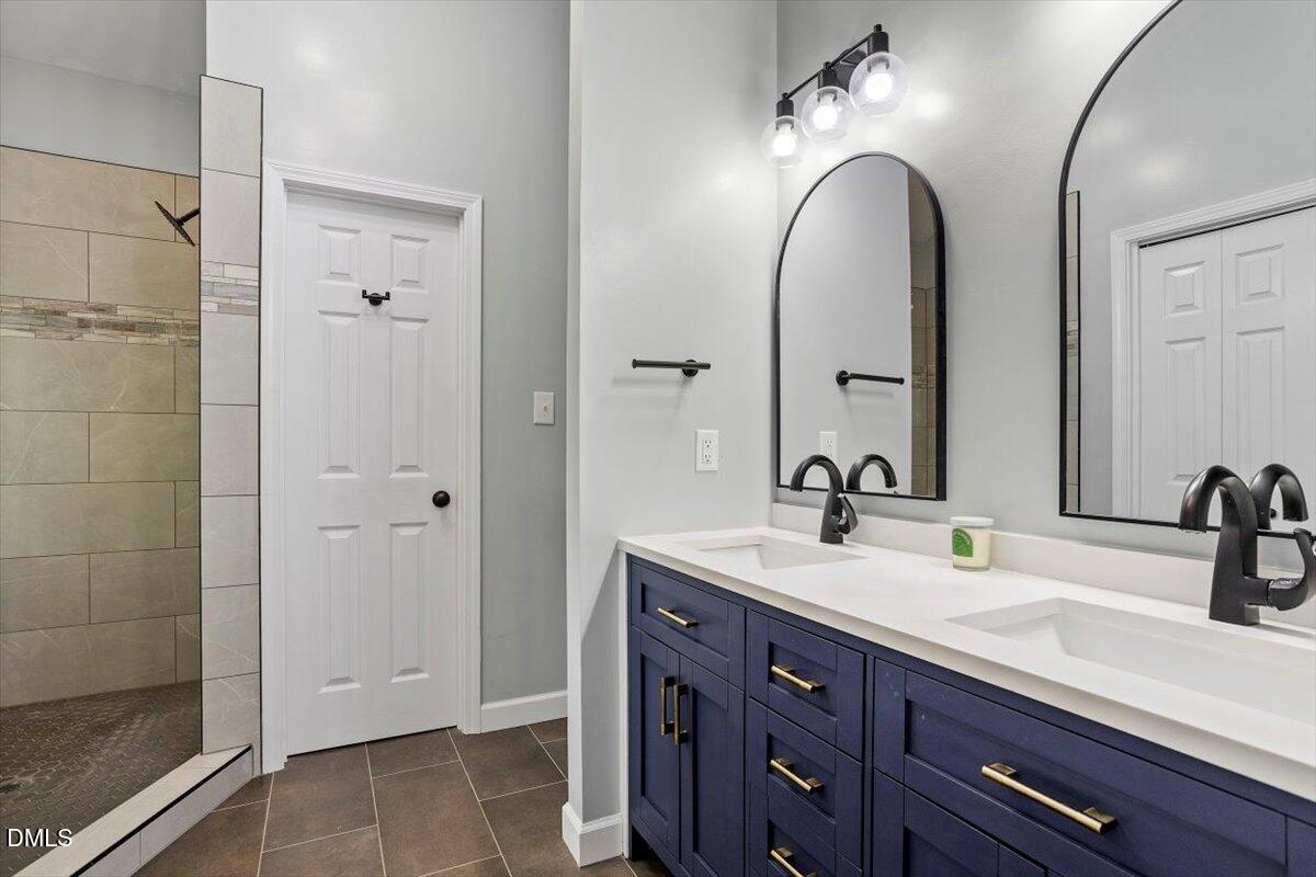 309 Appaloosa Trail Bahama, NC 27503 - Photo 23 of 45 a bathroom with a double vanity sink and a mirror