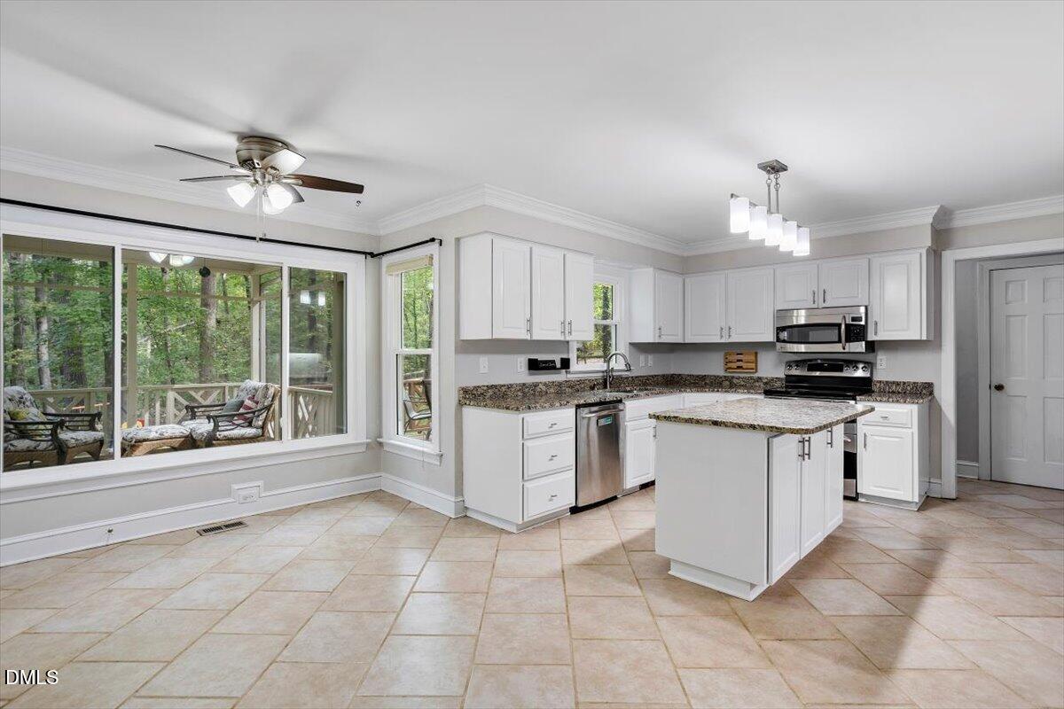 309 Appaloosa Trail Bahama, NC 27503 - Photo 3 of 45 a kitchen with a stove a sink and a refrigerator