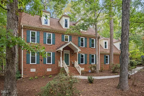 an aerial view of a house with a yard and garden
