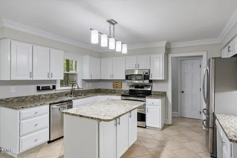 a kitchen with a sink stove and refrigerator
