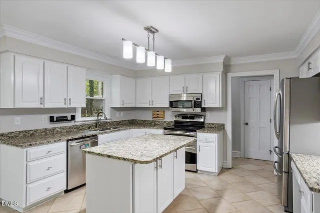 a kitchen with a sink stove and refrigerator