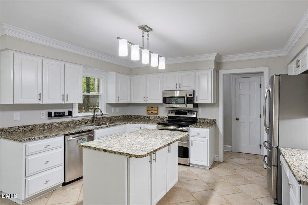 309 Appaloosa Trail Bahama, NC 27503 - Photo 4 of 45 a kitchen with a sink stove and refrigerator