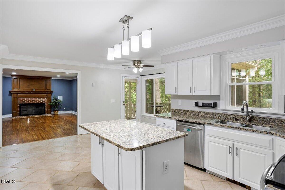 309 Appaloosa Trail Bahama, NC 27503 - Photo 7 of 45 a kitchen with kitchen island granite countertop a sink cabinets and window