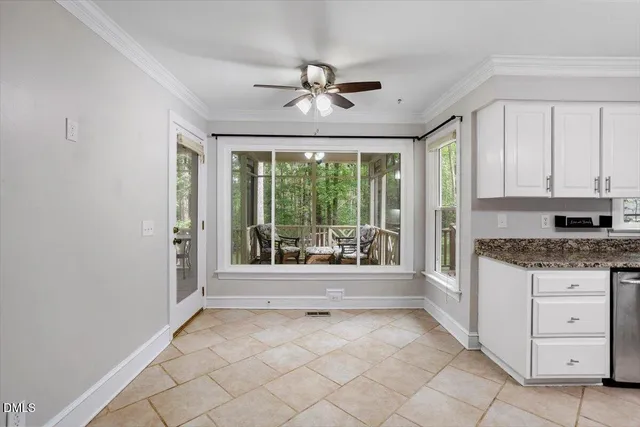 a view of a kitchen with a sink and a large window