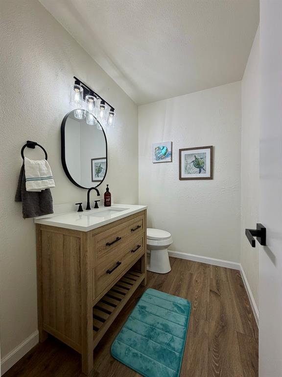 3609 Country Club Road Arlington, TX 76013 - Photo 18 of 40 a bathroom with a toilet a sink and mirror