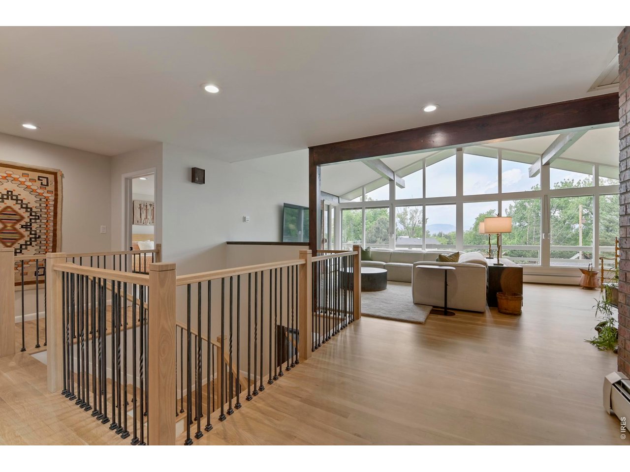 19 Ridge Road Boulder, CO 80303 - Photo 11 of 49 New custom built white oak railing and stairs to lower level and black iron spindles.