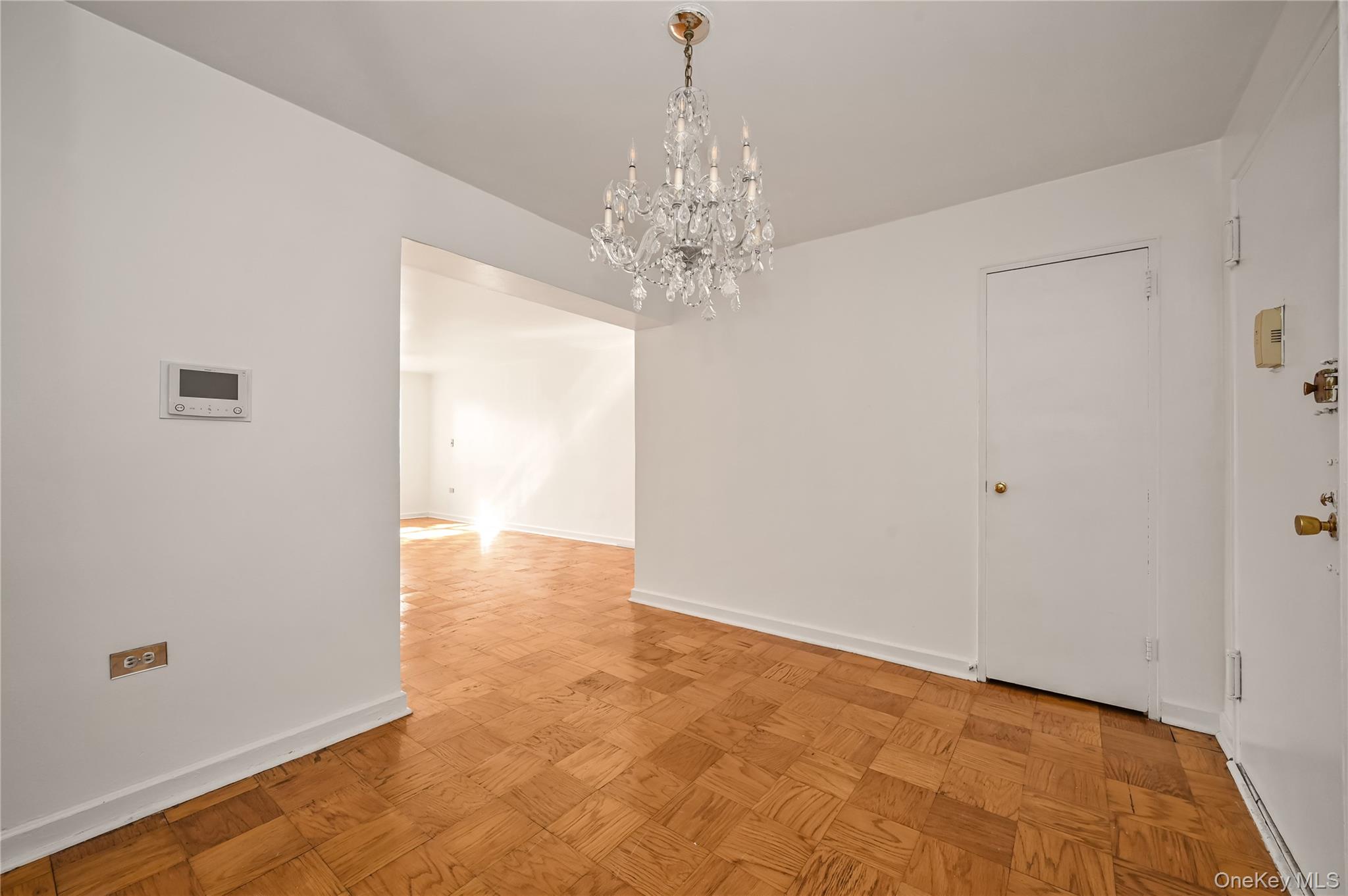 99-10 60th Avenue, Unit 1E Queens, NY 11368 - Photo 3 of 18 a view of a chandelier in big room and chandelier