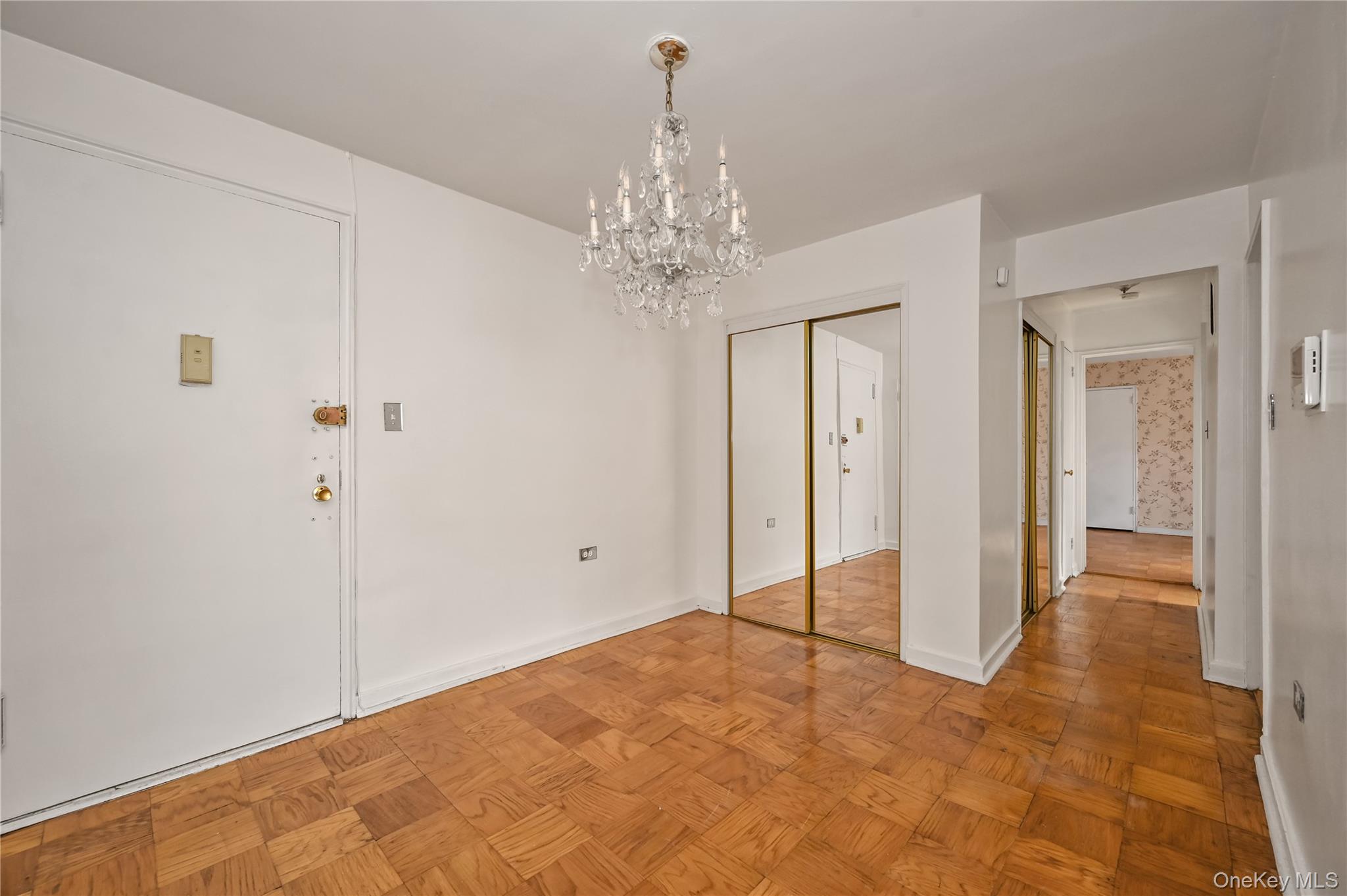 99-10 60th Avenue, Unit 1E Queens, NY 11368 - Photo 4 of 18 a view of a chandelier in big room and a bathroom