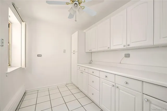 a kitchen with white cabinets and white appliances