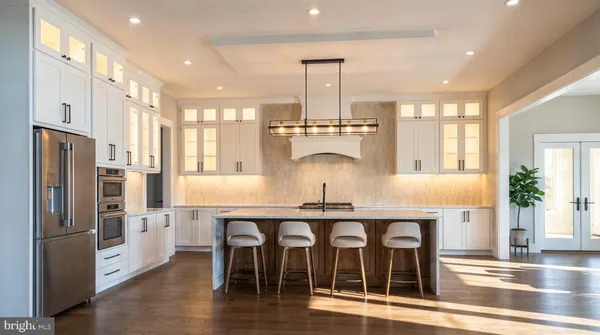 a kitchen with stainless steel appliances granite countertop a kitchen island hardwood floor and a sink