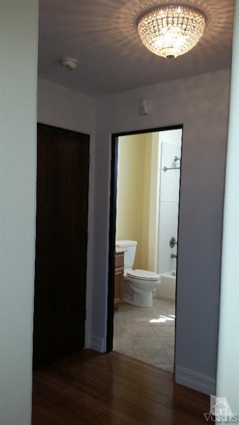 1430 Windshore Way Oxnard, CA 93035 - Photo 12 of 55 a view of a hallway with wooden floor and a living room