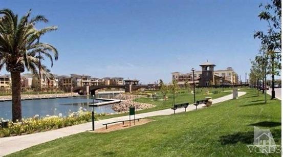 1430 Windshore Way Oxnard, CA 93035 - Photo 32 of 55 a view of a lake with a yard and mountain view