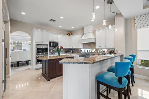 a kitchen with granite countertop a sink stove and cabinets