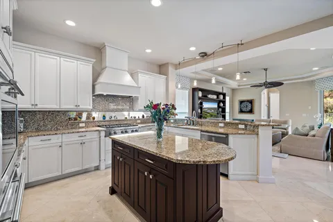 a living room with furniture ceiling fan and a window