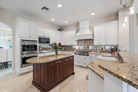 a view of a hallway with wooden floor and windows