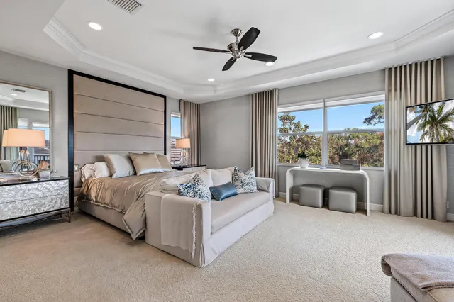 a bedroom with bed and a large window