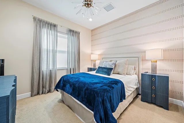 a bedroom with a bed and a chandelier