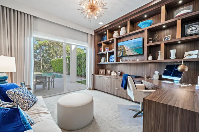a living room with furniture and a floor to ceiling window
