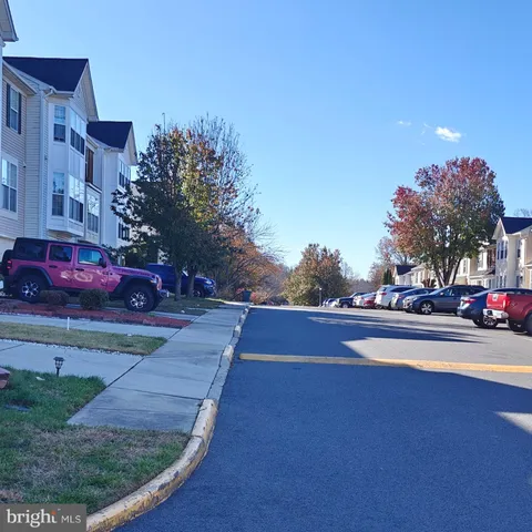 a view of empty room with wooden floor and entryway