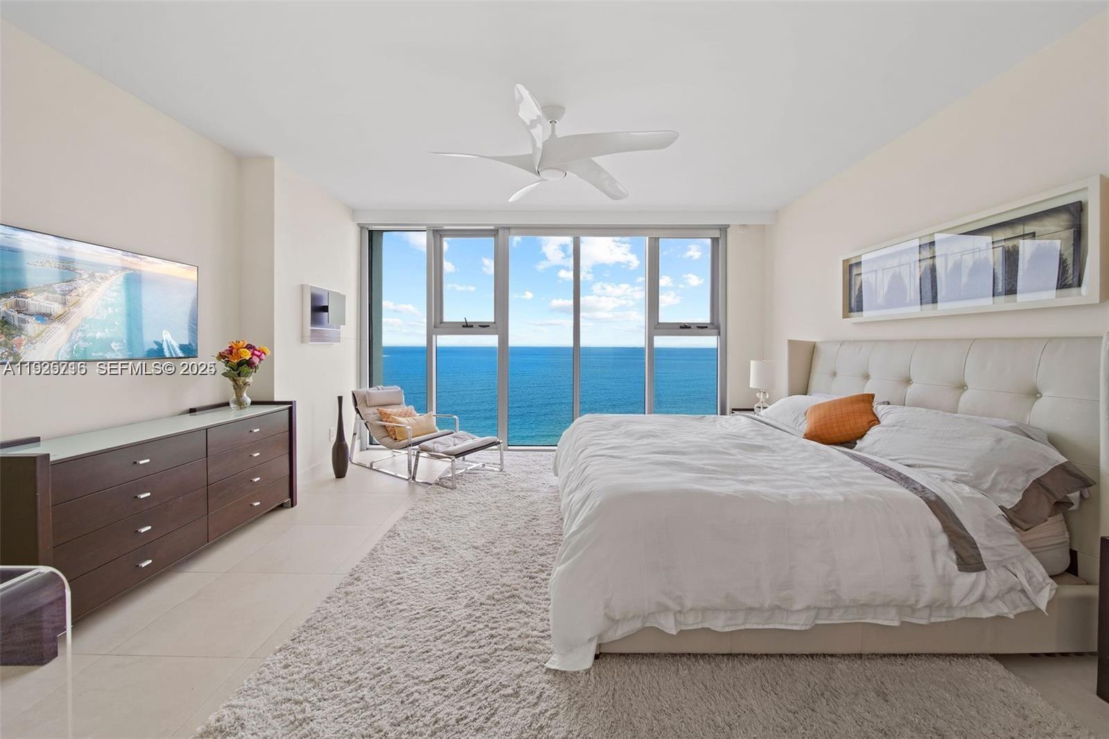 6899 Collins Avenue, Unit 1801 Miami Beach, FL 33141 - Photo 15 of 67 a bedroom with a large bed and a dresser