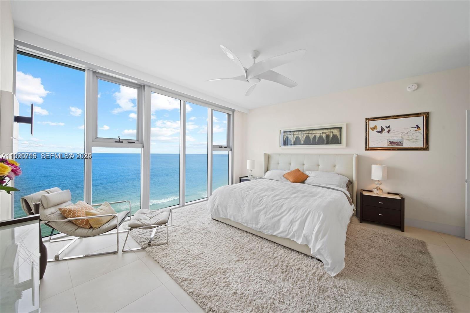 6899 Collins Avenue, Unit 1801 Miami Beach, FL 33141 - Photo 17 of 67 a bedroom with a bed and a large window