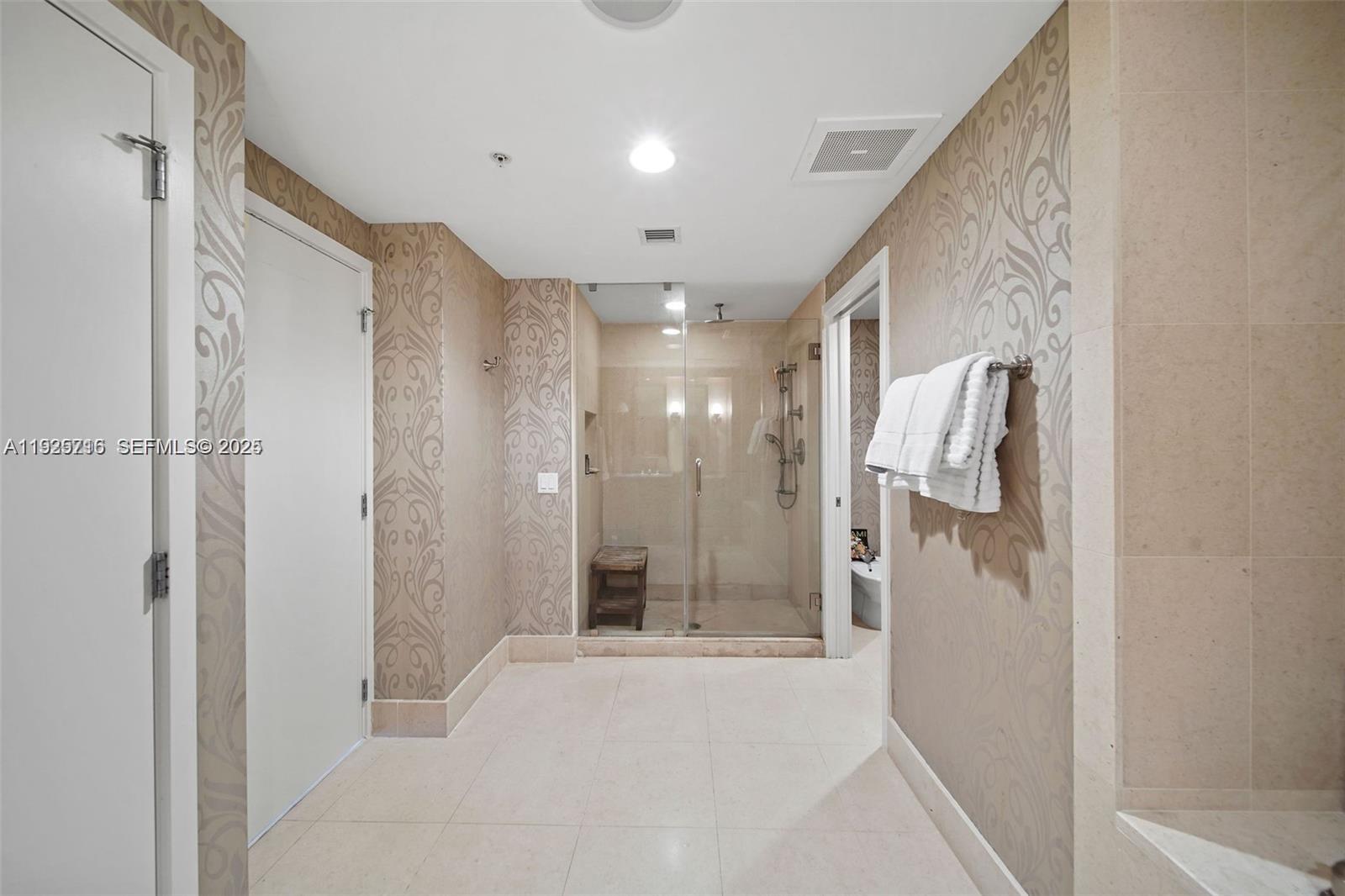 6899 Collins Avenue, Unit 1801 Miami Beach, FL 33141 - Photo 20 of 67 a bathroom with a shower and a glass door