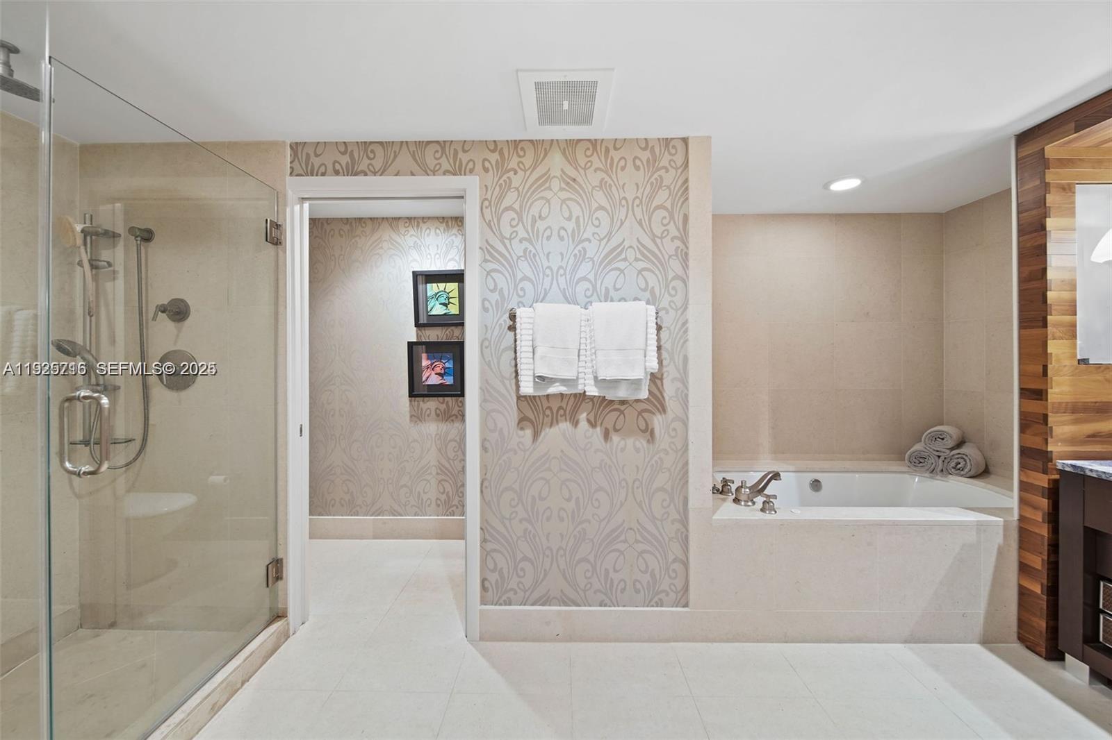 6899 Collins Avenue, Unit 1801 Miami Beach, FL 33141 - Photo 21 of 67 a bathroom with a bathtub and a shower