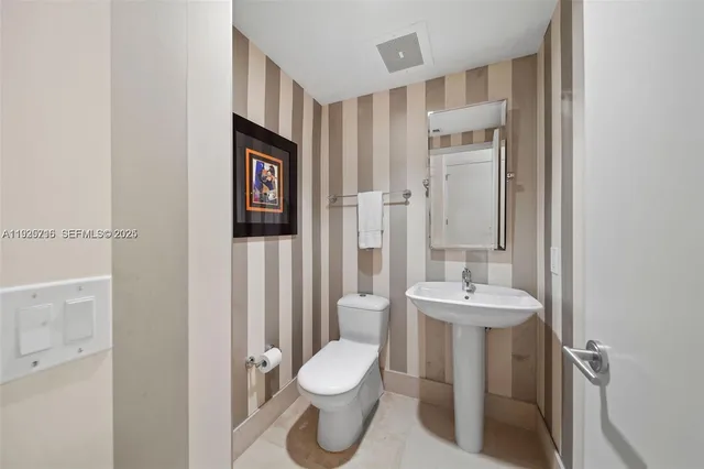 a bedroom with two beds and a chandelier