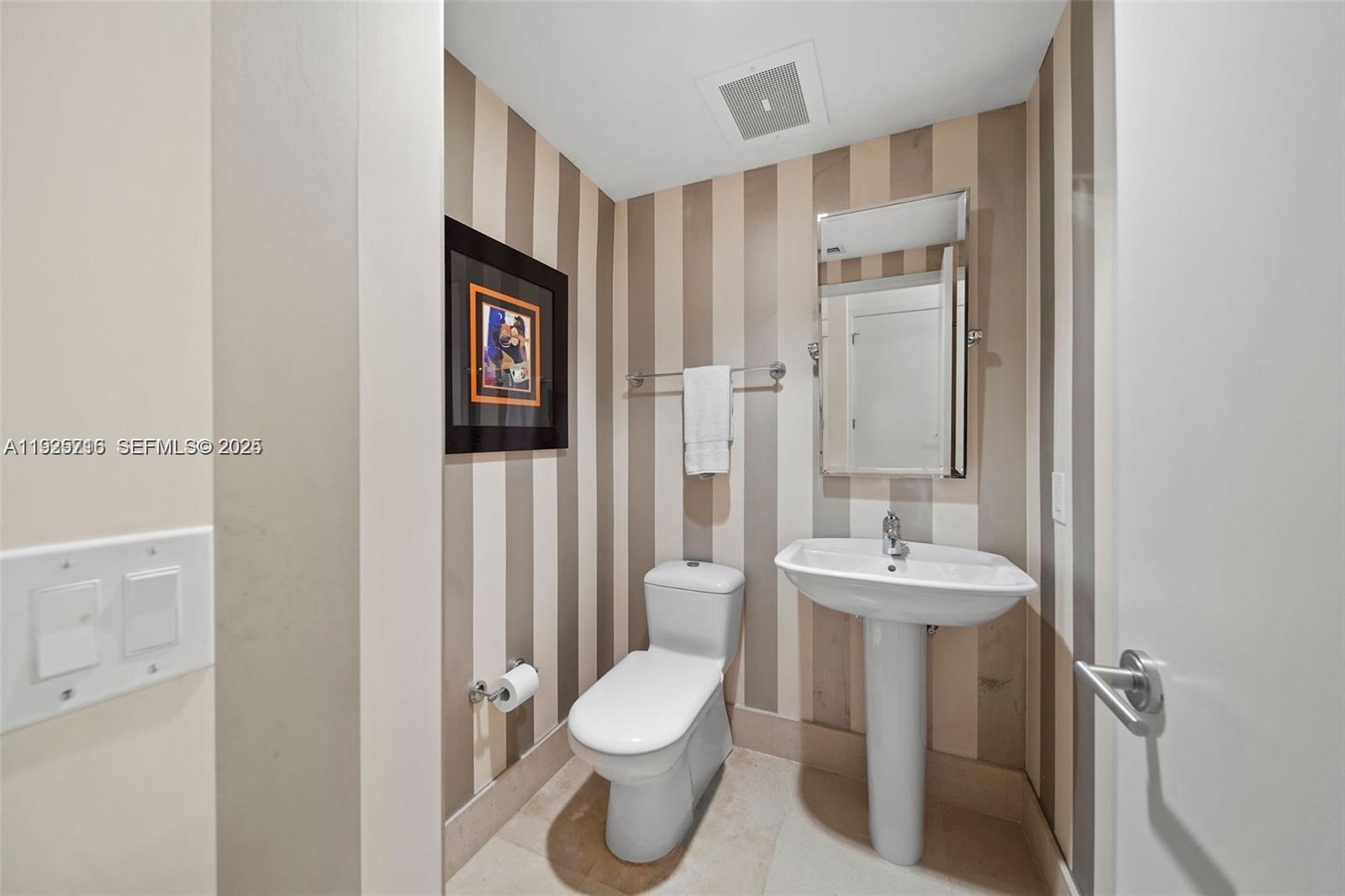 6899 Collins Avenue, Unit 1801 Miami Beach, FL 33141 - Photo 22 of 67 a bathroom with a toilet sink shower and mirror